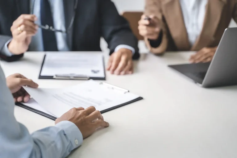 Human resources professionals reviewing documents in a meeting.