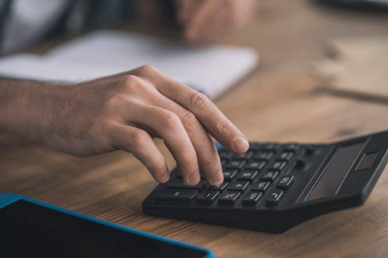 Man using the calc for accounting calculations